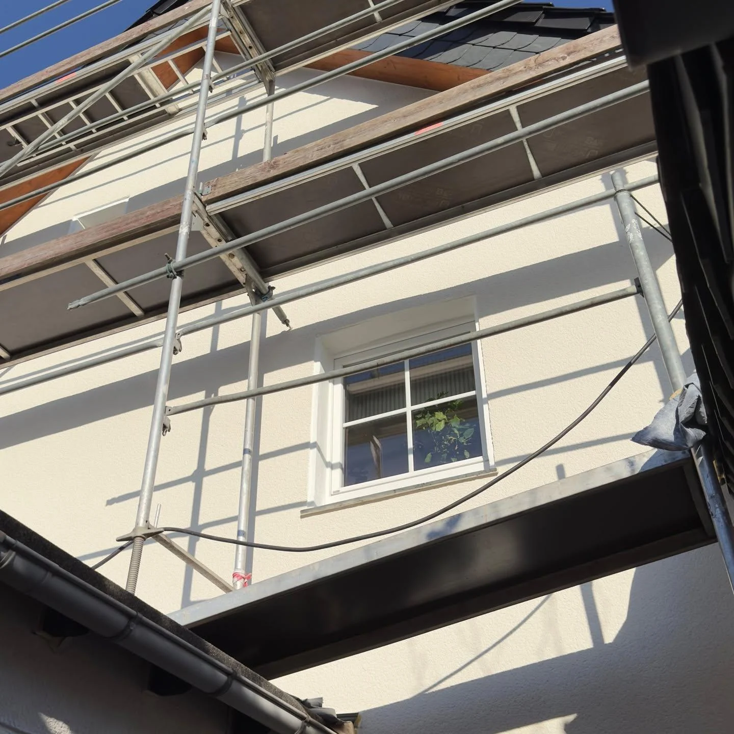 Frisch verputztes weißes Einfamilienhaus mit Dachsolaranlage